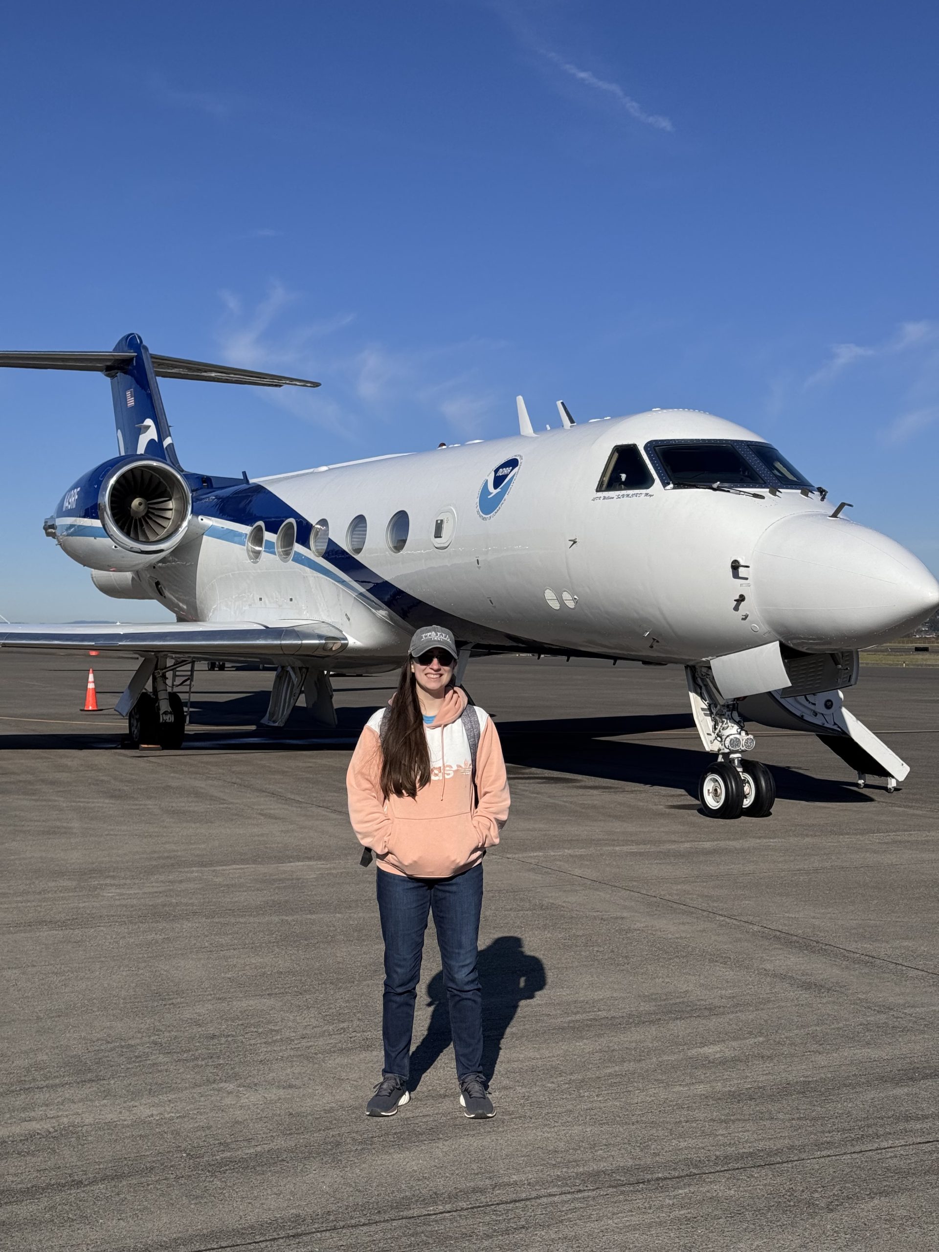 Student in front of plane